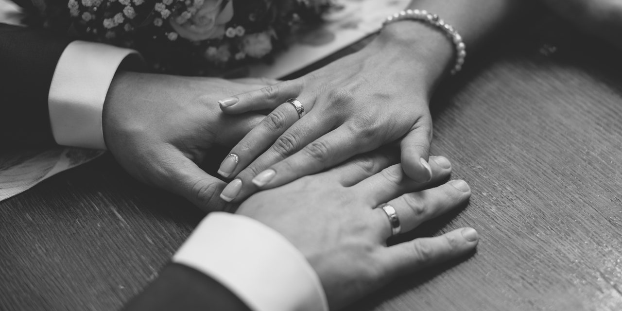 couples-hands-on-table-wedding